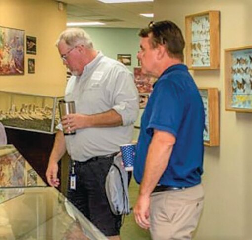 SFWMD Dan Cotter and James Harbaugh viewing the artifacts at Clewiston Museum.